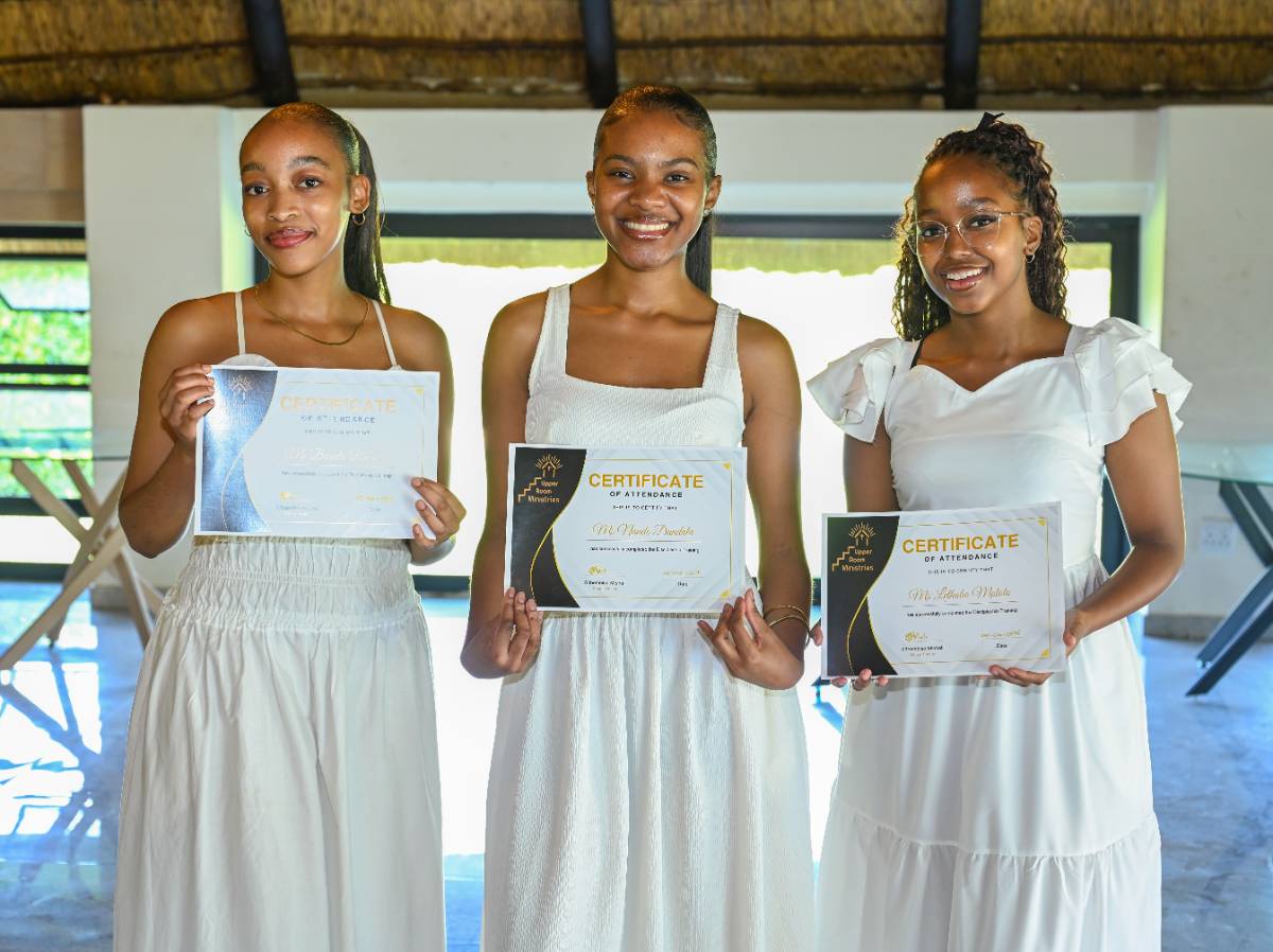 Graduates holding their certificates